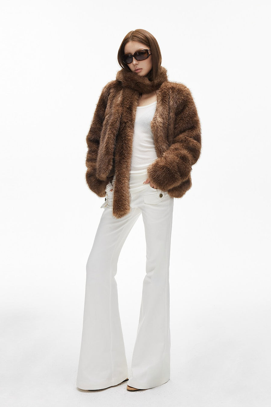 Woman in brown fur coat with white jeans winter outfit